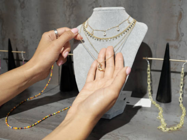 Woman wearing multiple pendants on a single chain